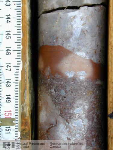 Photo 2005-171A : Strates de la Formation de Read dans une carotte du sondage RL-68. a) Couche de mudstone rouge entre des couches de conglomérat à gros cailloux à  ...