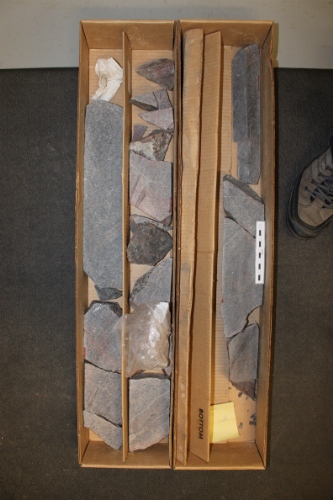 Photo 2019-385: Core boxes showing the granodiorite basement core (scale bar is 10 cm in length).