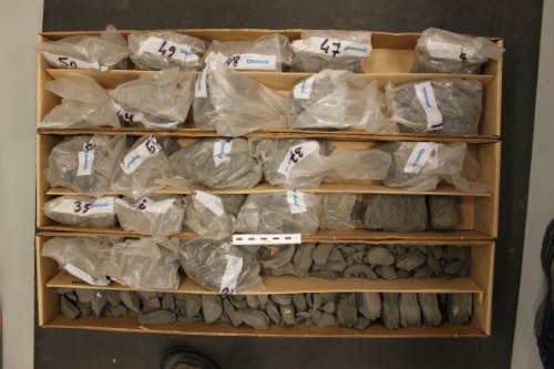Photo 2019-472: Photographs of core 3, Skolp E-07 showing the core boxes. The rubbly core materials recovered from the base of the well have been bagged. Scale bars  ...