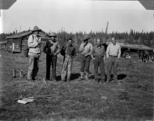 Photo 202083J : The joint topographical and geological party at Pelly Crossing, Yukon. From left to right topographies, W.H. Miller (later director of Surveys and  ...