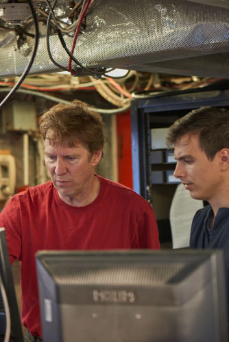 Photo 2021-306 : part of a cruise participants photo collage for newsletter; Brian and Cam examine the multibeam image