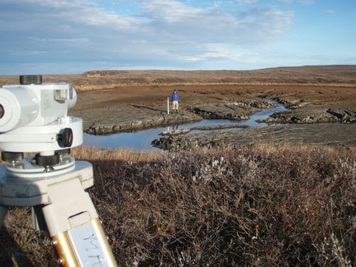 Photo 2021-642 : Environment Canada staff surveying surface of drained lake, Mackenzie Delta region, Northwest Territories.